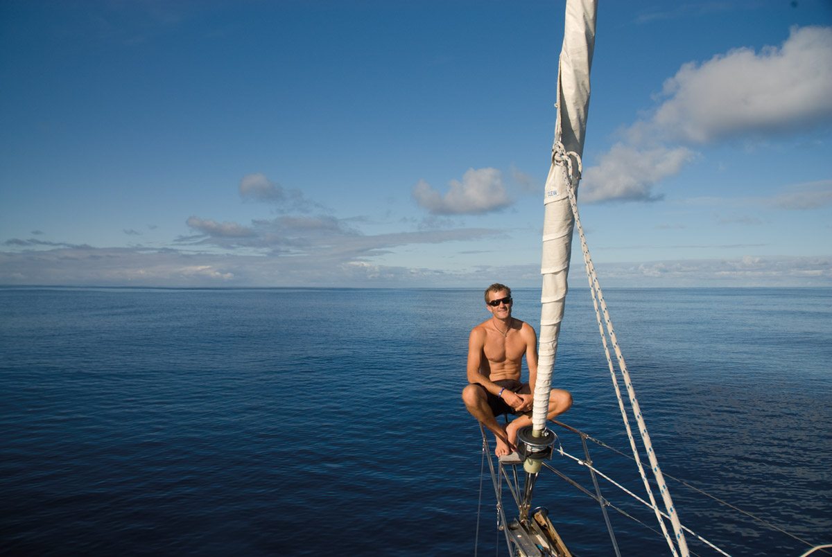 Bryson Robertson fins deep in market research. Top right: Robertson relaxes on the prow of the Ocean Gybe vessel Khulula.