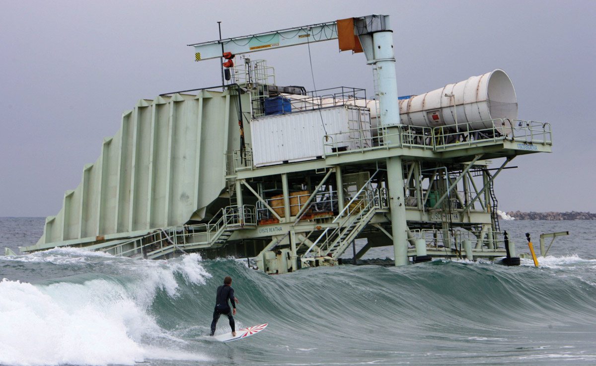 alternative energies Norwegian Sondre Oie surfs in front of the long-defunct Oceanlinx wave generator off southeastern Australia’s coast, near Port Kembla.