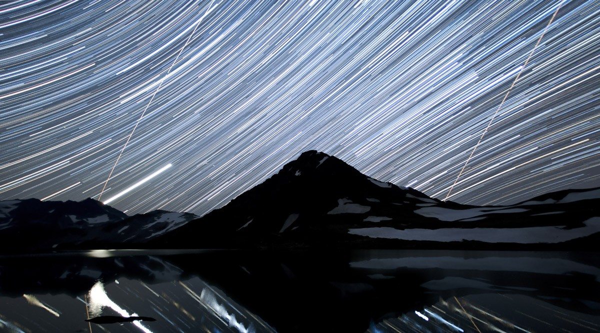 Star trails over Whistler’s Fissile Peak and reflected in Russet Lake. The two straight lines are satellite trails.