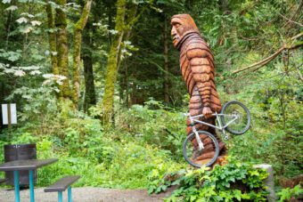 bigfoot statue carries bike in BC